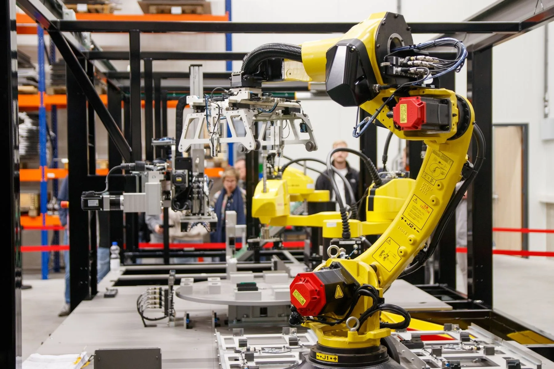 An industrial robot arm on a production line in a manufacturing hall