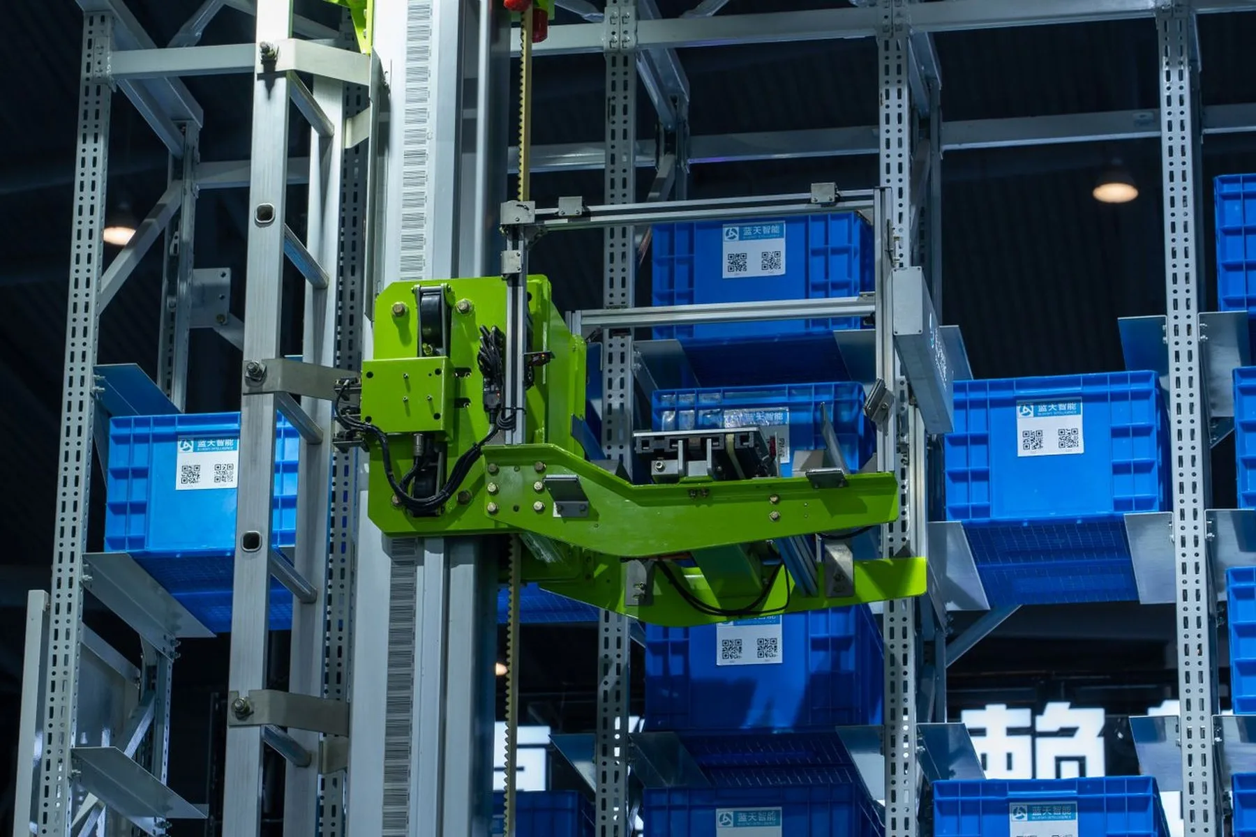 A robotic handling unit moving crates in an automated warehouse